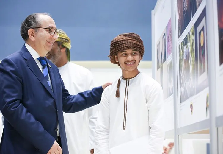 A picture with the President of the International Federation of Photography (FIAP) Riccardo Bossi at the Youth Exhibition 2018 and receiving an appreciation award